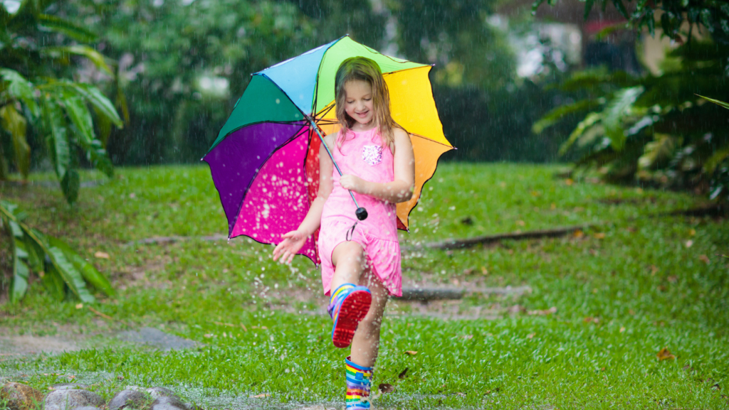 little girl splashing in puddles