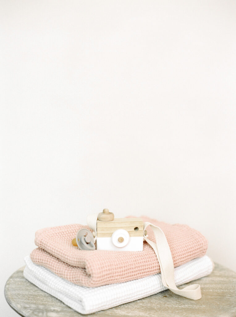 baby blankets and wooden toy camera