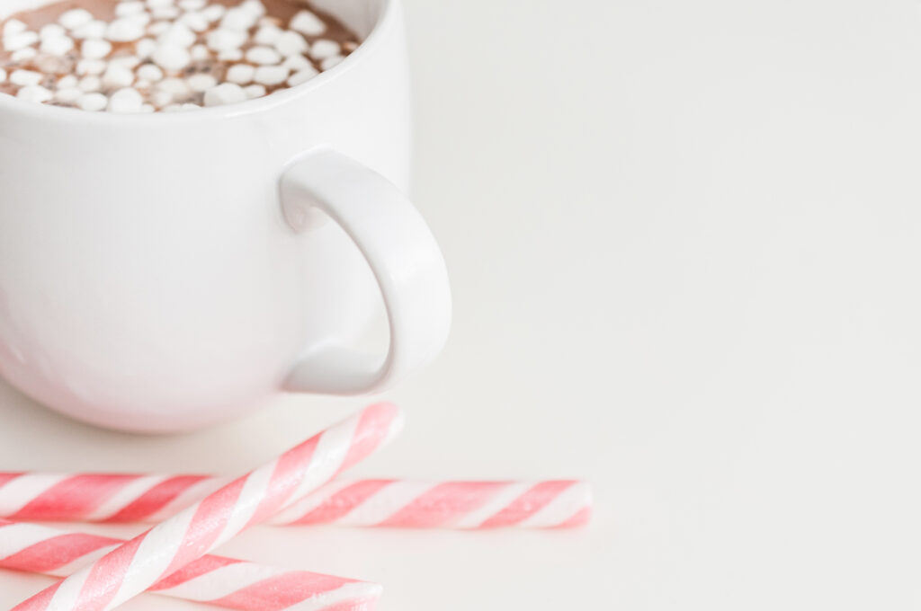 hot chocolate with mini marshmallows and peppermint sticks
