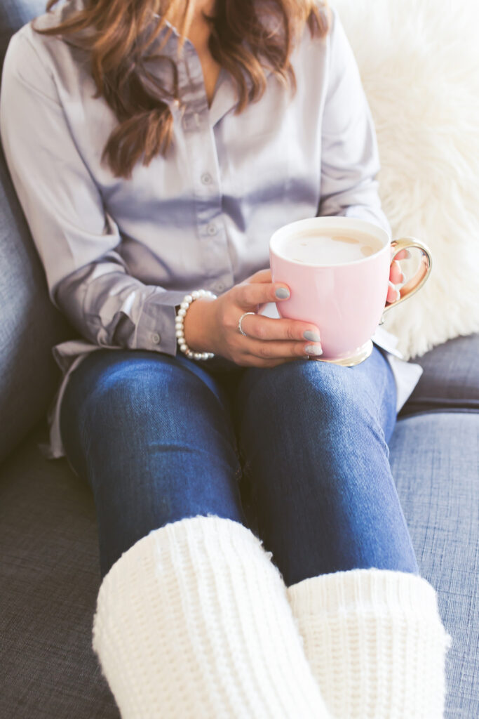 a girl in jeans drinking coffee