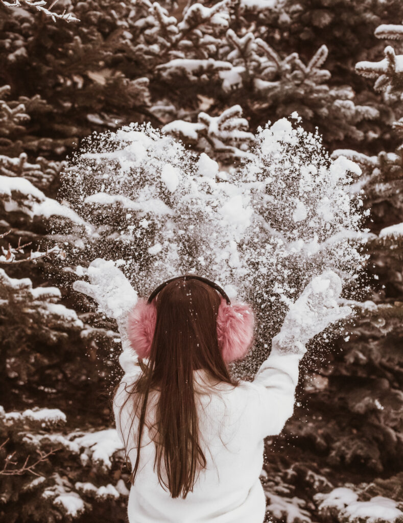 girl throwing snow
