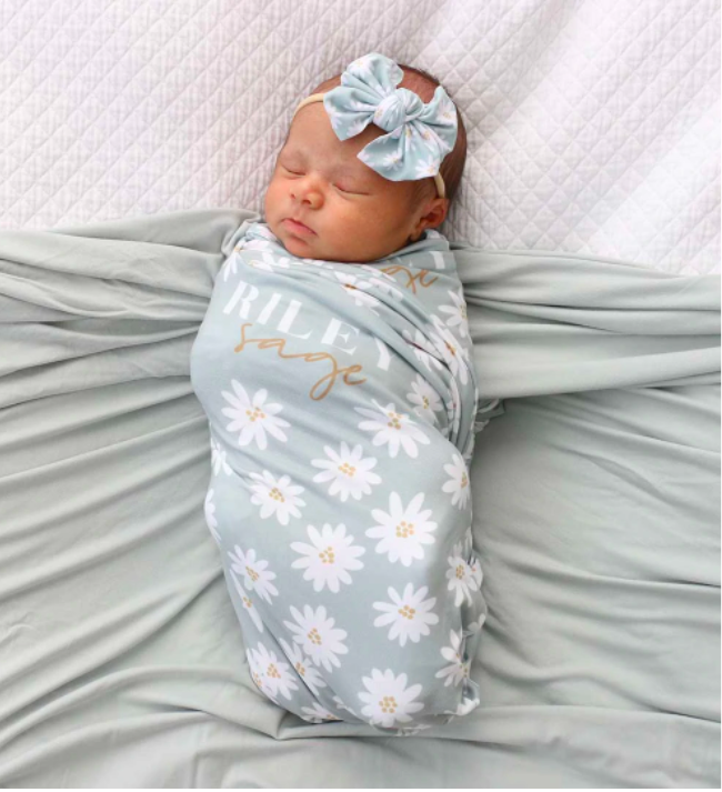 daisy swaddle blanket on baby girl