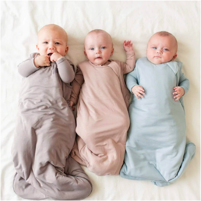 three babies in sleep sacks